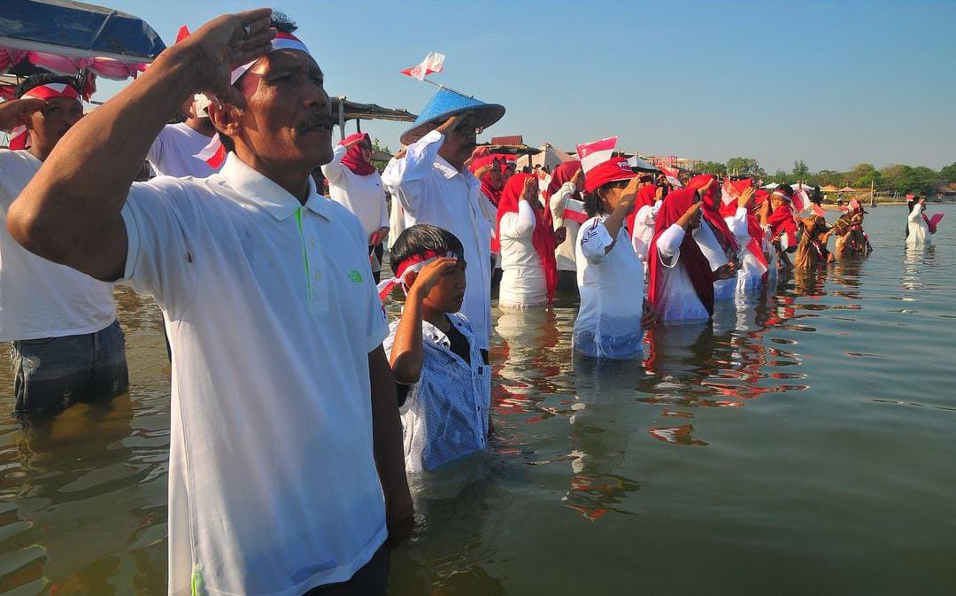 Warga pesisir pantai pelayaran Karang Kebagusan, Kabupaten Jepara, melaksanakan upacara HUT RI ke-79 di tepi laut. (Foto: Instagram/ussfeeds)